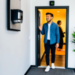 Smart Lock Security**

"A modern, brightly lit co-living entryway with a smart lock on the door. A diverse group of fully clothed young professionals are seen entering and exiting, using key fobs. Interior design elements include plants and a welcome mat. Safe for work, appropriate content, fully clothed, professional, perfect anatomy, natural proportions, well-formed hands, proper finger count, high-resolution, security camera visible in the corner, professional photography, modest environment."

**